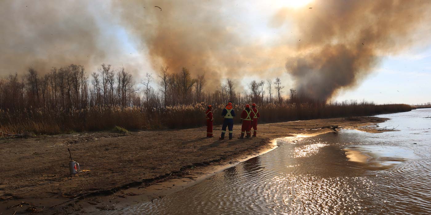 2022: TEK fire practitioners monitoring a burn in the Saskatchewan River Delta.